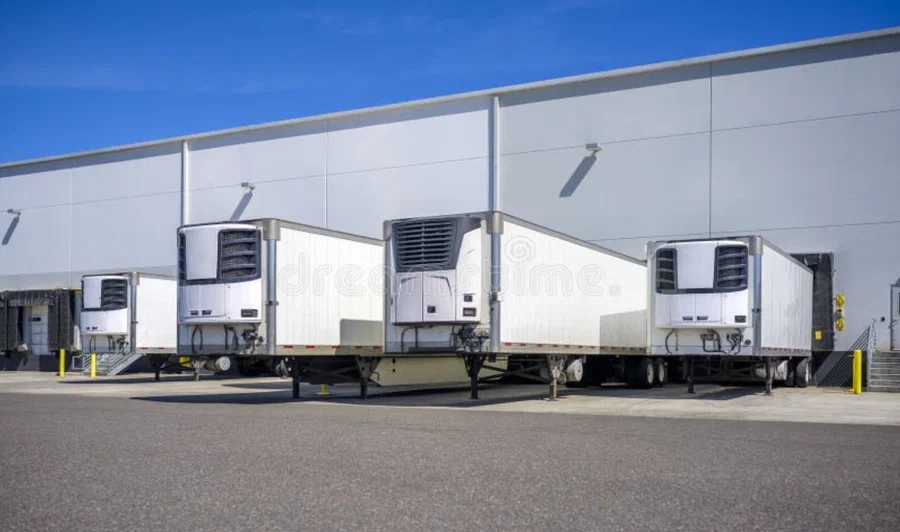 Refrigerated trailers backed into loading docks