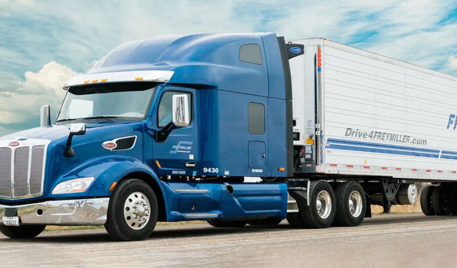 Royal blue semi-truck pulling a refrigerated trailer