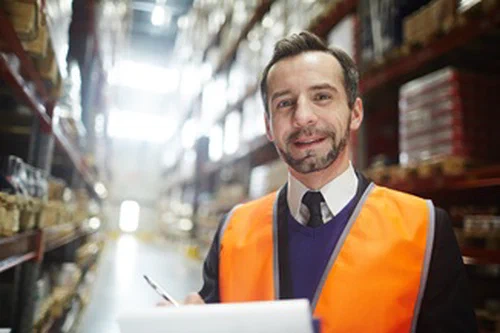 A man wearing a tie inside a wearhouse.