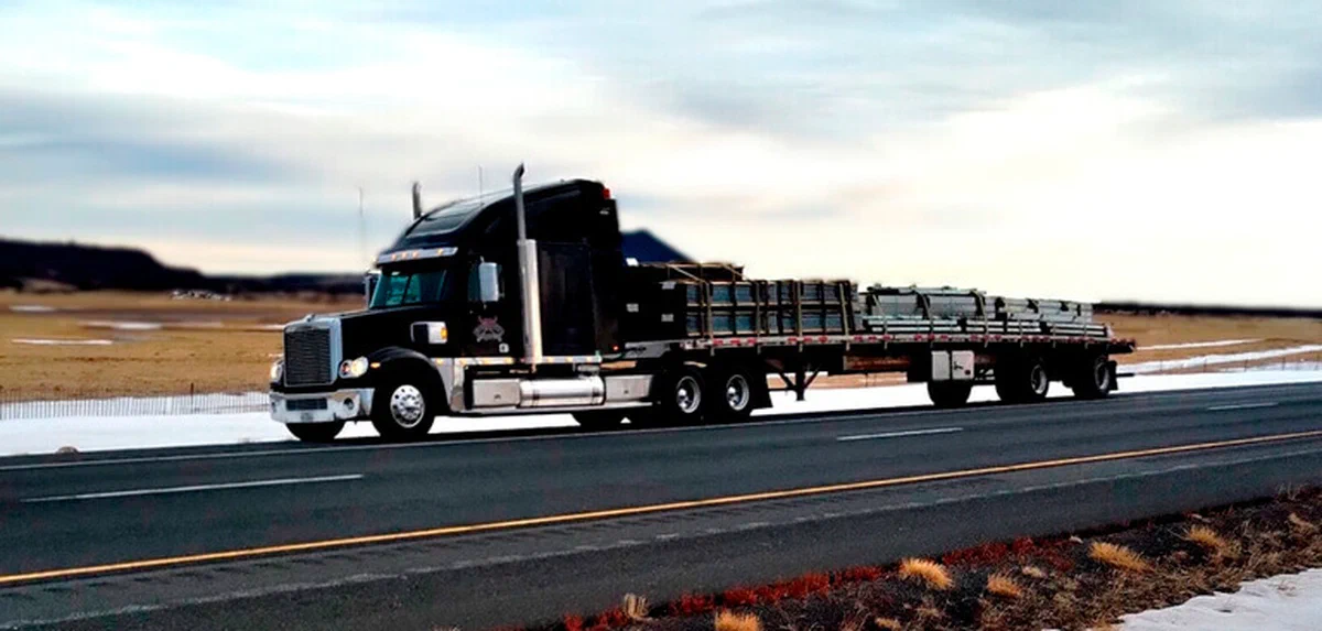 A photograph of an oversized freight load on a trailer. A photograph of an oversized freight load on a trailer.