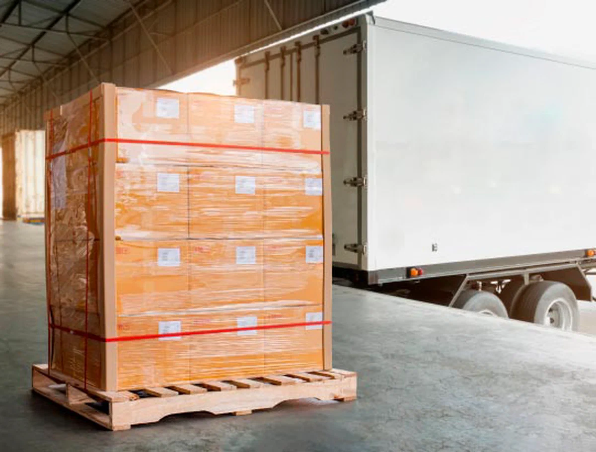 Trailer positioned at a warehouse loading dock for freight transfer.