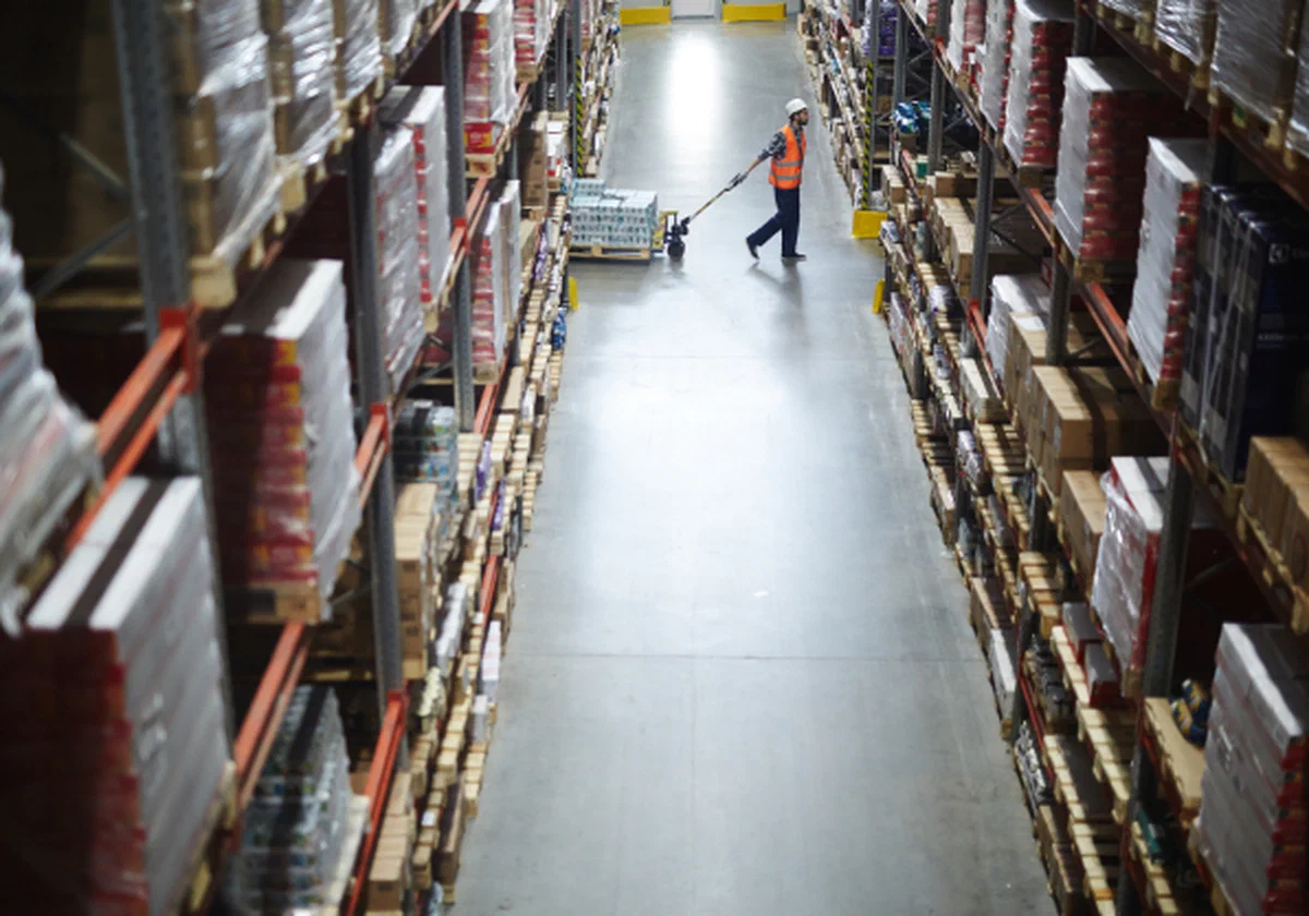 Distribution and fulfillment Warehouse staff reviewing inventory from the warehouse floor.